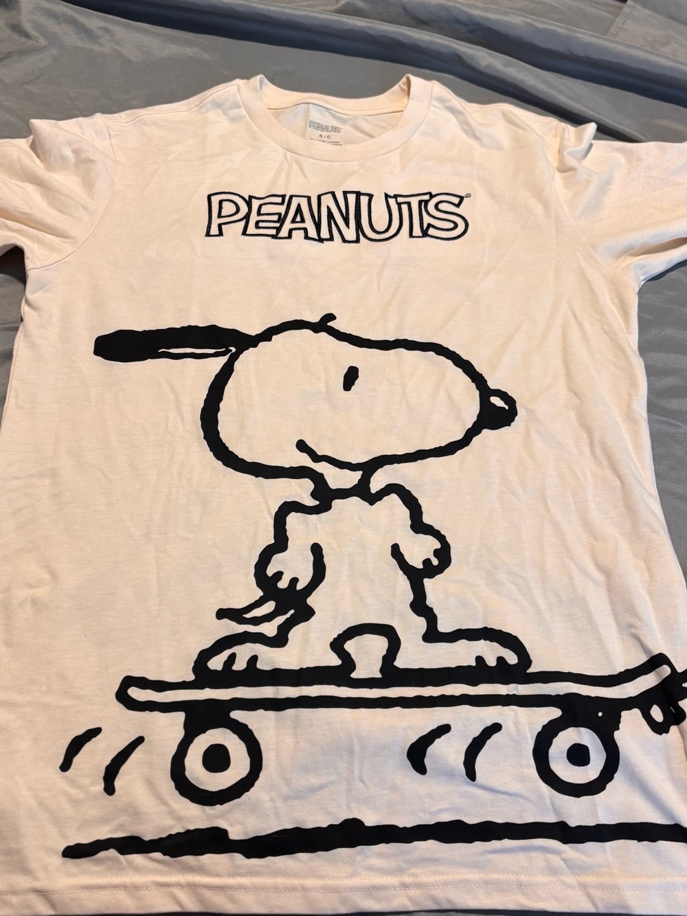 Peanuts White Kids Tee with Black Snoopy Skateboard Graphic